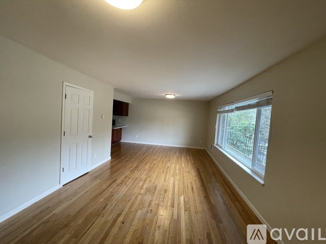 A room with wooden floors and a white door.
