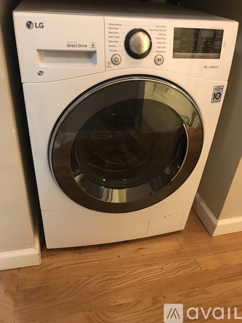 An LG washing machine with a white front and a black door.