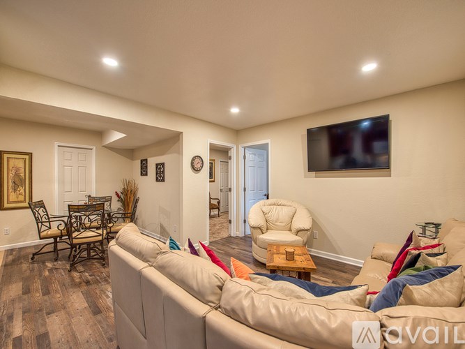 A living room with a white couch and a wooden coffee table.