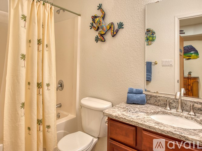 A bathroom with a toilet, sink, and shower curtain.