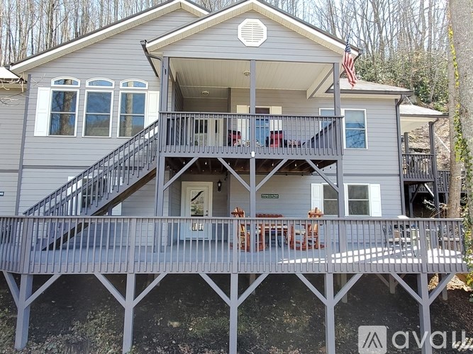 A two-story house with a balcony and a deck.