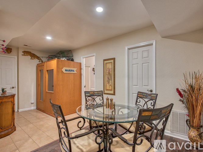 A dining room with a glass table and chairs.