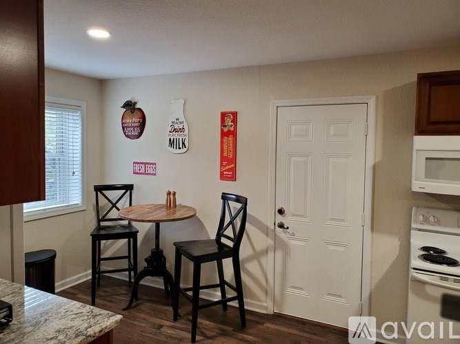 A kitchen with a table and chairs in the middle of the room.