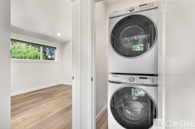A washer and dryer are stacked on top of each other in a laundry room.