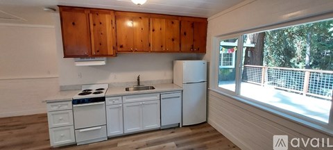 A kitchen with wooden cabinets and white appliances.