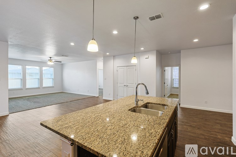 A kitchen with granite countertops and a sink.