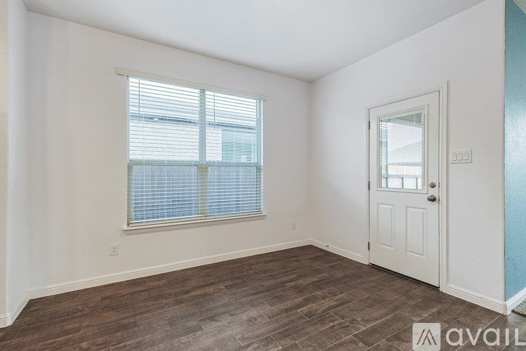 A room with a window and a door is available for rent.