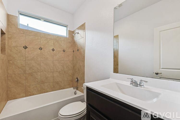 A bathroom with a toilet, sink, and bathtub.