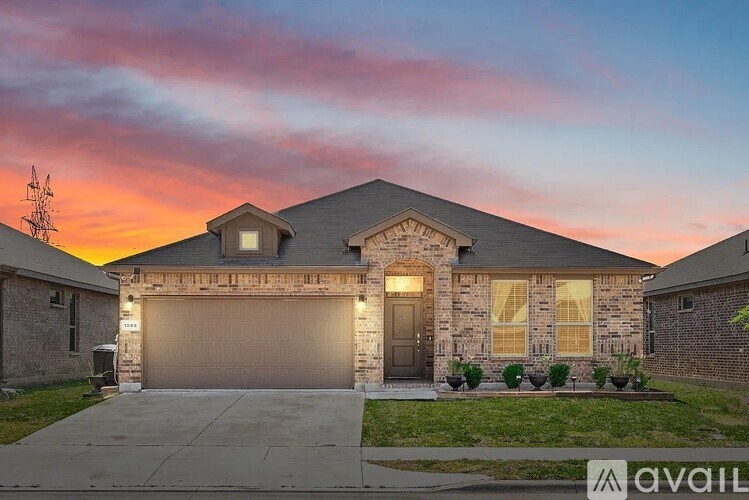 A house with a garage and a driveway in front of it.
