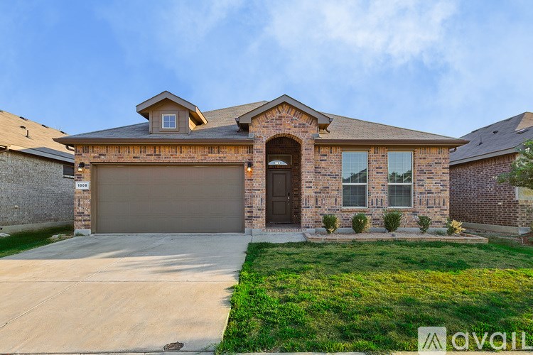 A house with a garage and a driveway is available for sale.