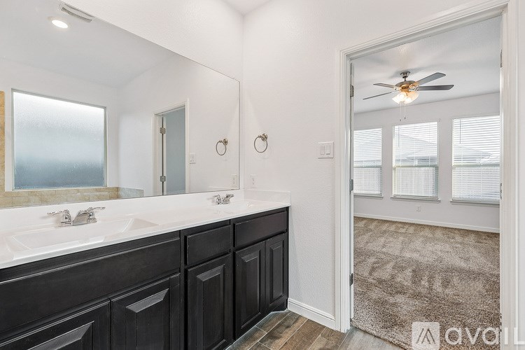 A bathroom with a vanity and a mirror.