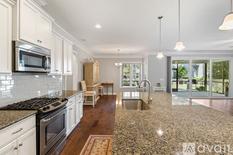 A kitchen with granite countertops and a stove top oven.