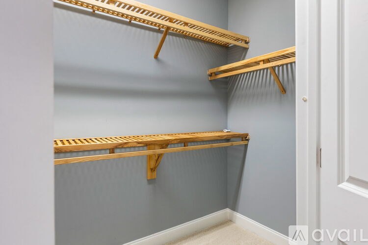 Three wooden shelves on a wall.