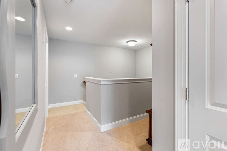 A room with a white door and a white wall.