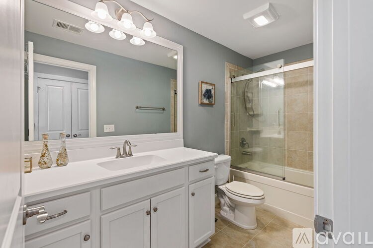 A bathroom with a white sink and toilet.