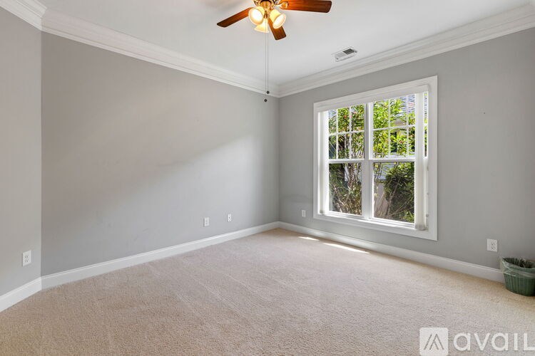 A room with a ceiling fan and a window.
