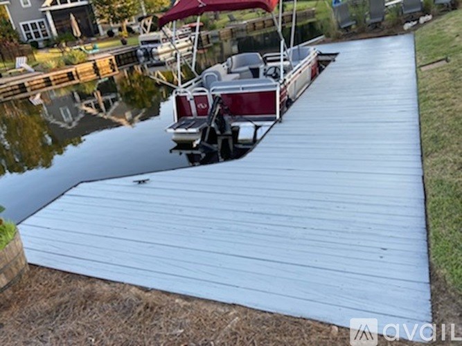 A boat is docked at a wooden dock.