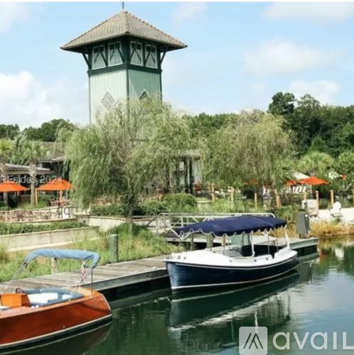 A boat is docked at a pier with a tower in the background.