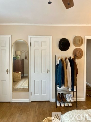 A room with a coat rack and a mirror.