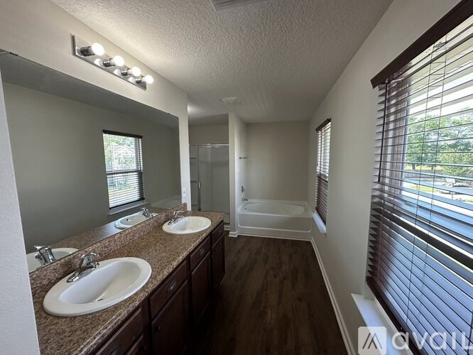 A bathroom with two sinks and a bathtub.