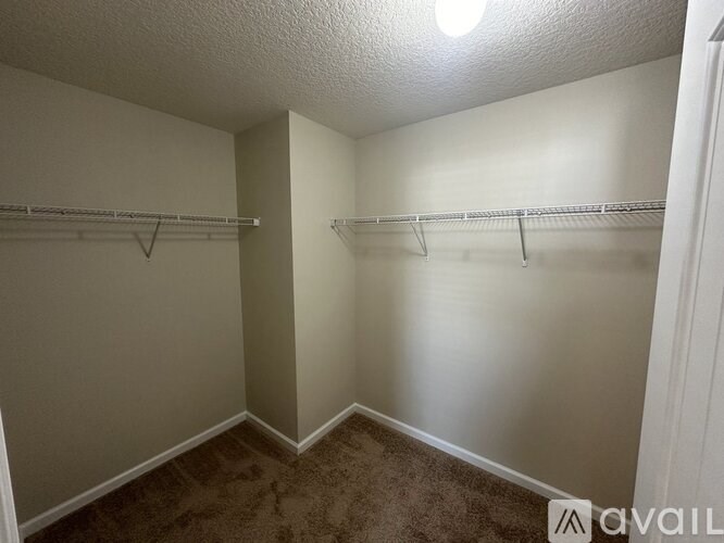A room with two empty shelves and a carpeted floor.