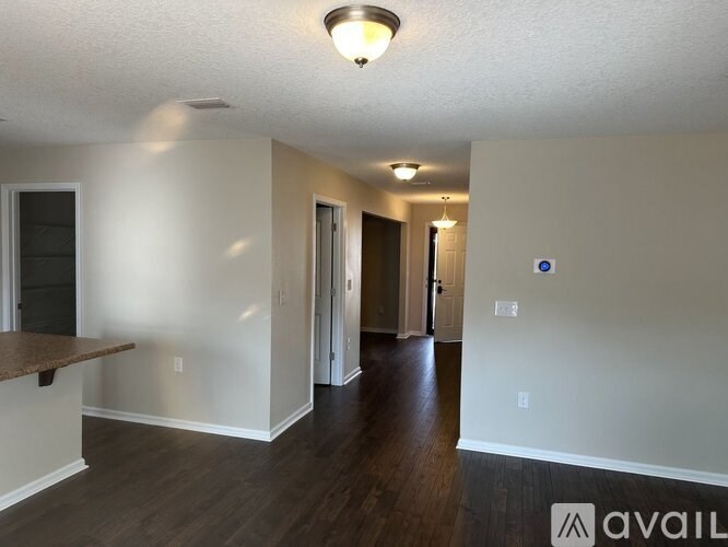 A room with a brown counter top and white walls.