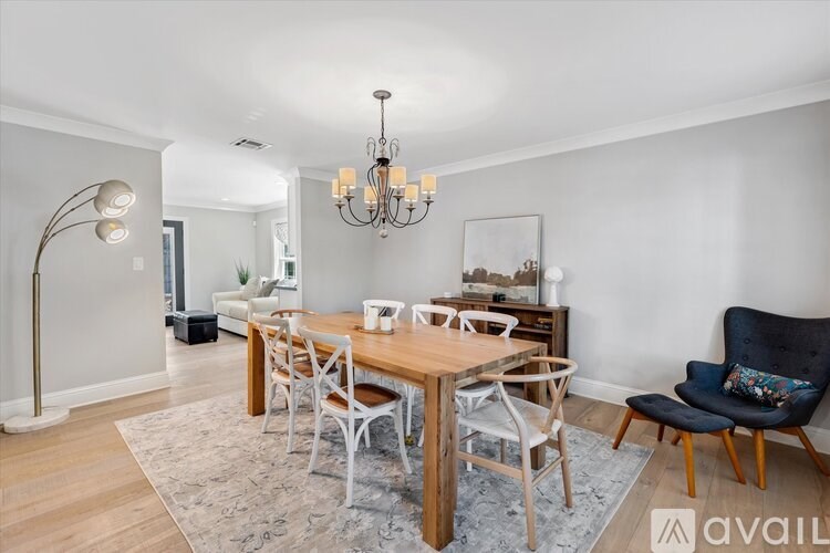 A dining room with a wooden table and chairs.