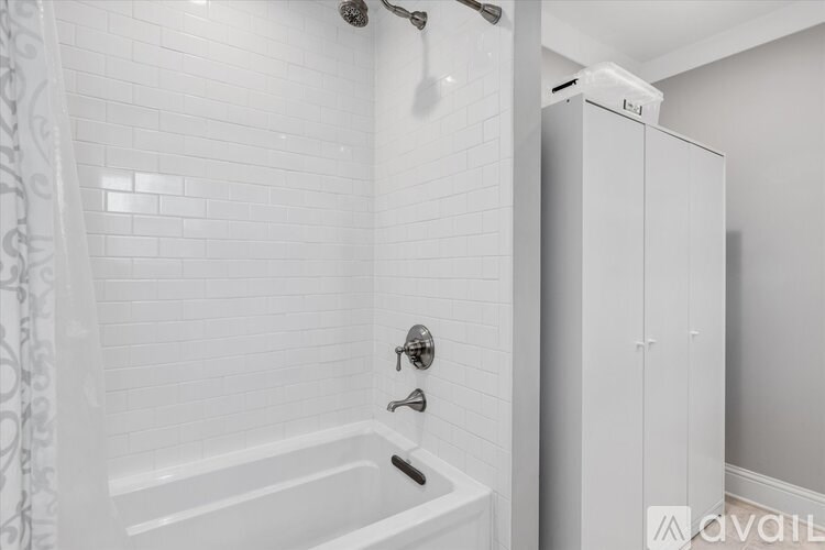 A white bathroom with a tub and shower.