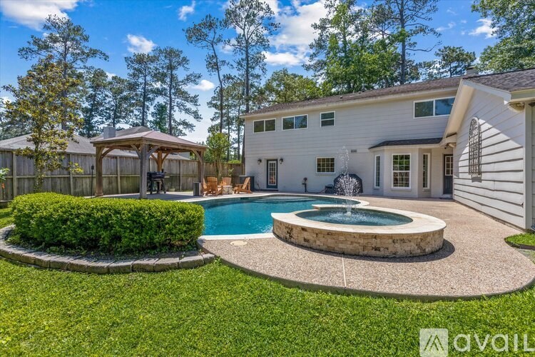 A house with a pool and a gazebo in the backyard.