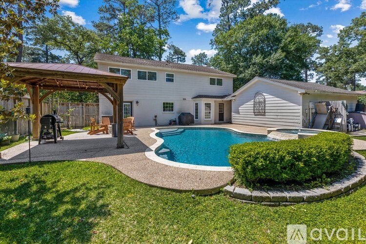 A house with a pool and a covered patio area.
