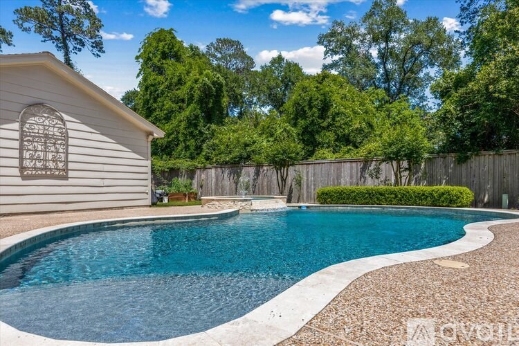 A pool with a white border and a house with a window in the background.