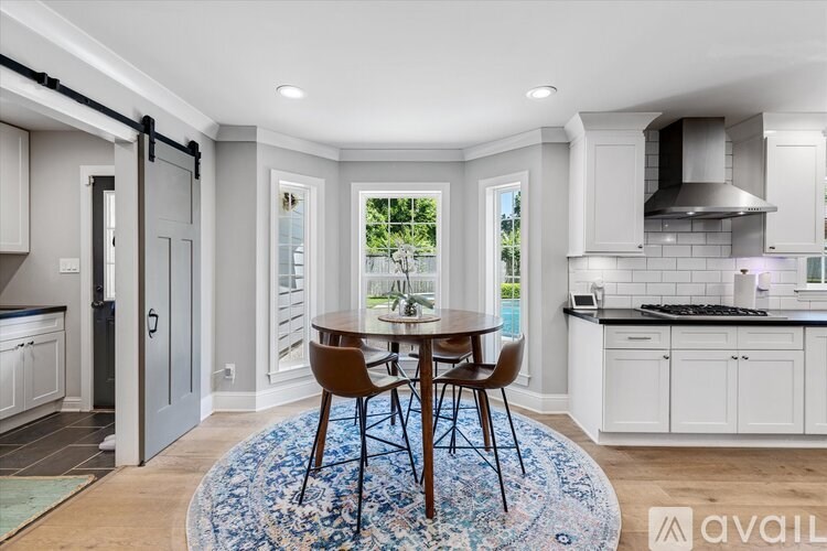 A kitchen with a table and chairs in the middle of the room.