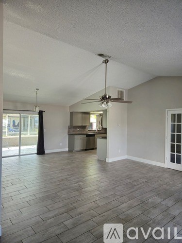 A room with a fan and a logo that says "avaiL" on the floor.