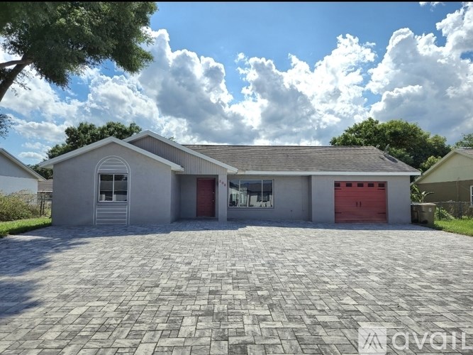 A house with a red garage door is for sale.