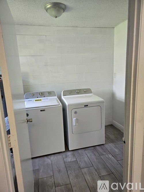 A small laundry room with a washer and dryer.