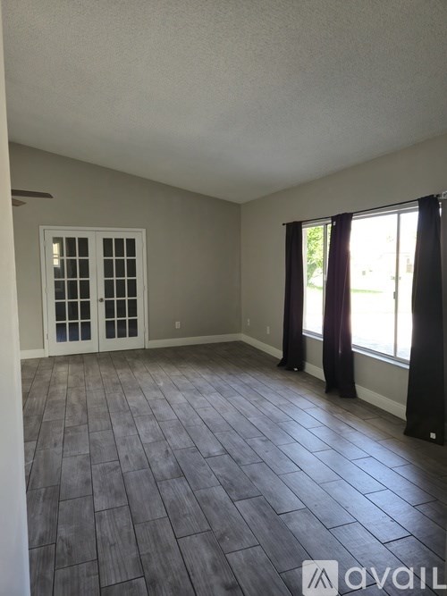 A room with a window and a door.