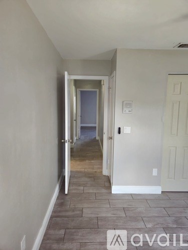 A hallway with a door at the end.