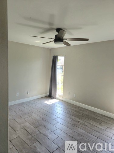 A room with a ceiling fan and lighting fixtures.