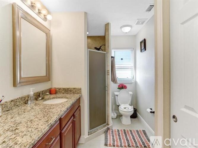 A bathroom with a sink, toilet, and shower.