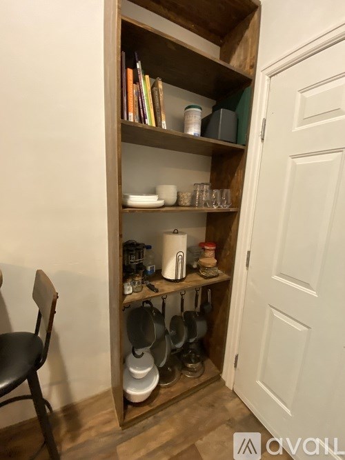A wooden shelf with various items on it.