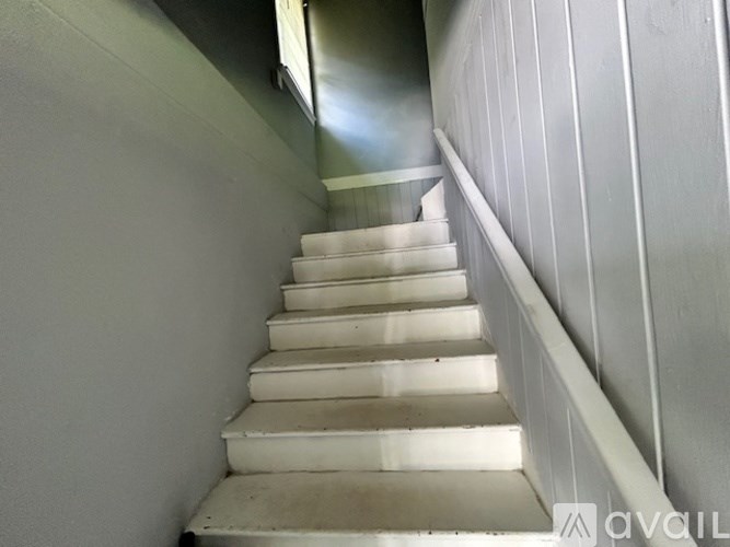 A set of stairs with a handrail on the side.