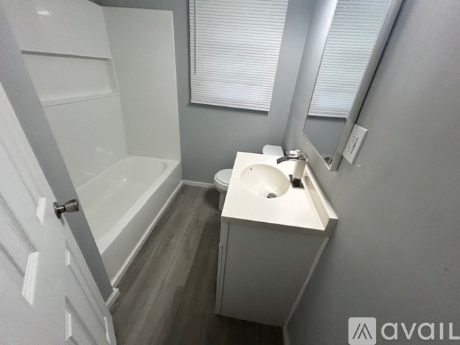 A small bathroom with a toilet, sink, and bathtub.