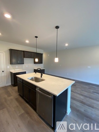 A kitchen with a sink and a refrigerator.