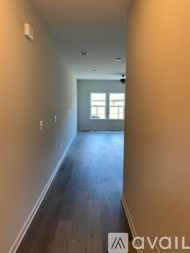 A long hallway with a door at the end.