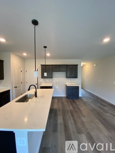 A kitchen with a white countertop and a sink.