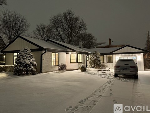 A house with a car parked in front of it.