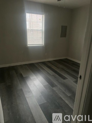 A room with a window and Avail logo on the floor.
