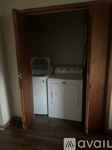 A small laundry room with a washer and dryer.