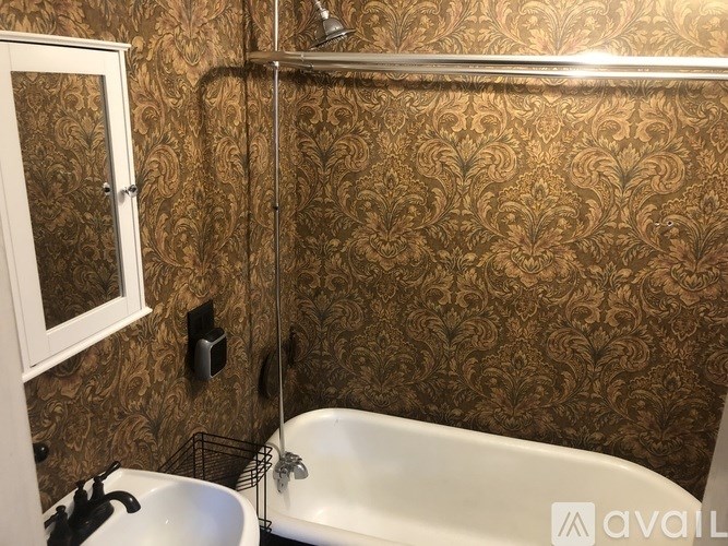A bathroom with a bathtub, toilet, and sink.