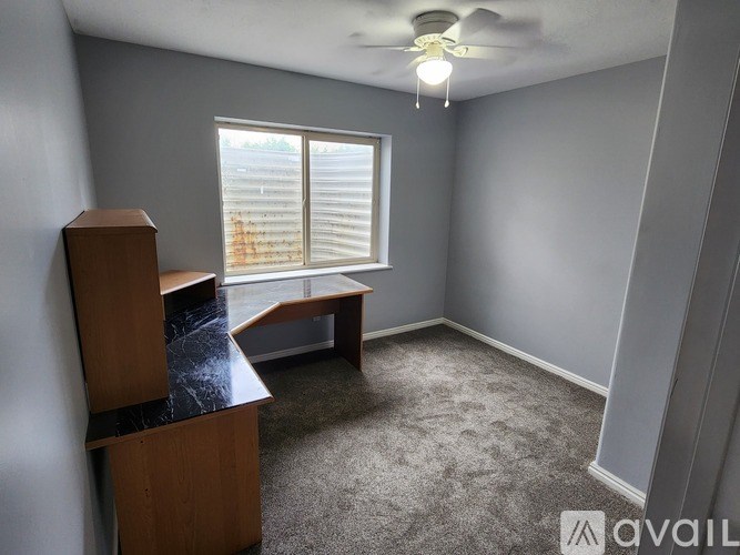 A room with a window and a bench.